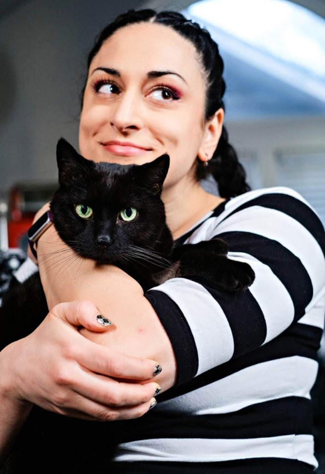 La Schaffer, Senior Product Designer, holding her black cat